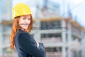 portrait of a female architect in a yellow helmet at a construct