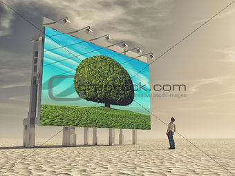 A young man looks at a billboard