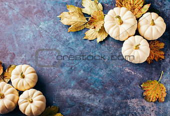Autumn background with small pumpkins
