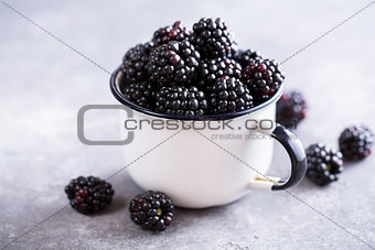 Juicy fresh blackberries in a cup.