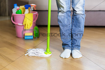 woman holding mop in the home.