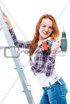 sexy young woman with a drill on a white background