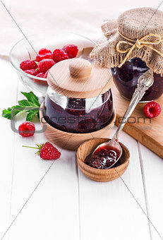 Raspberry confiture in can with fresh berries