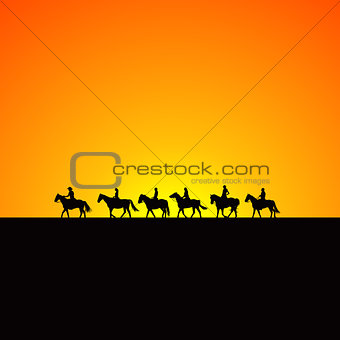 Horse riders silhouettes at sunrise