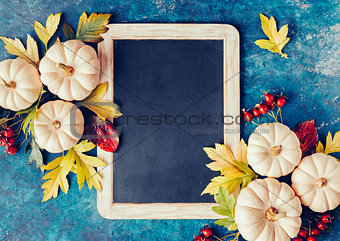 White pumpkins and fall leaves.