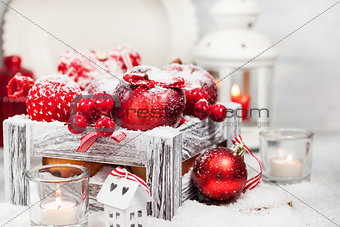 Christmas composition with red apples, balls, cinnamon, snow and