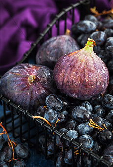 Fresh figs and purple grape in basket