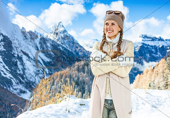 woman in front of mountain landscape looking into distance