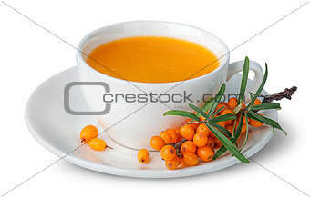 Juice from sea-buckthorn in a cup with berries