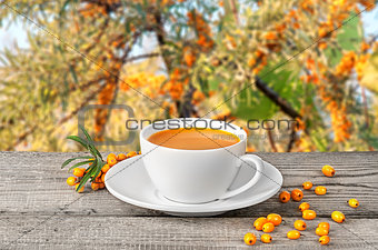 Tea of seabuckthorn berries on wooden table