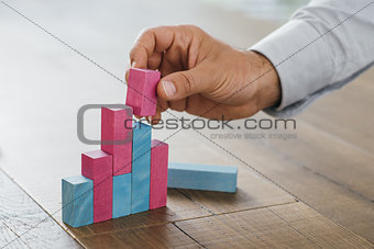 Businessman building a successful financial graph