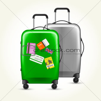 Wheeled suitcases with travel tags - silver and green baggage