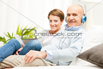 Couple relaxing together listening to music