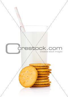 Glass of milk with round cheese crackers on white