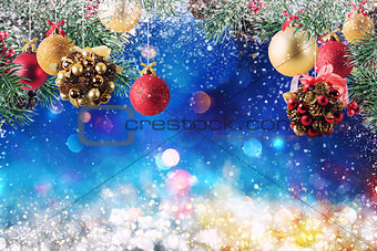 Christmas decoration with snow, pine and ball with sparkly background