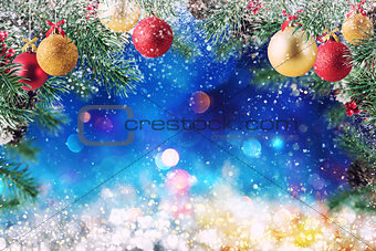 Christmas decoration with snow, pine and ball with sparkly background