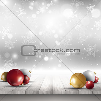 Christmas baubles on wooden deck 