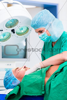 Orthopedic surgeon operating patient