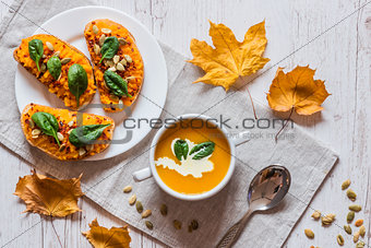 Pumpkin cream soup. Vegan healthy food. Breakfast or brunch on white wooden background