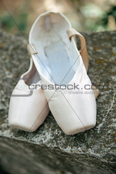 Pointe shoes for a classical ballerina, close-up on concrete