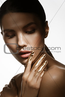 girl with golden paint on fingers