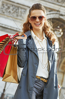 smiling young fashion-monger with shopping bags in Paris, France