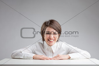 woman warmly laughing on a gray background