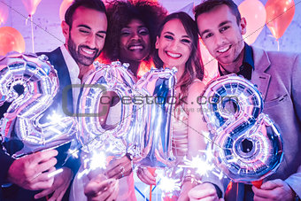 Group of party people celebrating the arrival of 2018