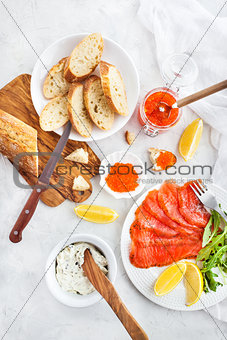 Delicious lunch with salted salmon, red caviar, fresh bread and 