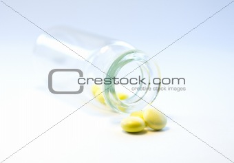 A glass bottle of yellow meds