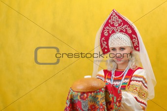 Russian woman in a folk russian dress Holds a bread