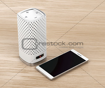 Speaker and smartphone on wood background