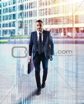 Determinated businessman walking in the city. double exposure