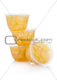 Single cups with pineapples in fruit jelly
