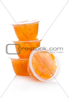 Single cups with peach in fruit jelly