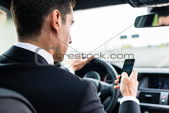 Man texting while driving by car
