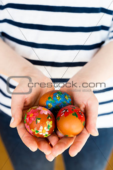 Close up of girl holding colorful painted Easter eggs