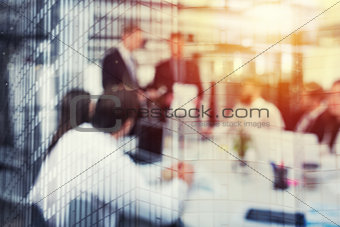 Blurred background of business people in office with futuristic effect