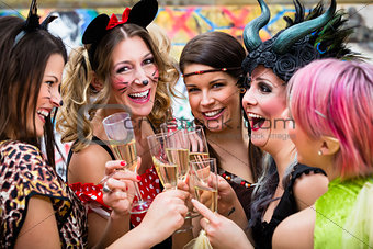 Girls at Carnival parade clinking glasses with champagne