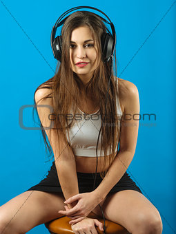 Sexy woman listening to music with headphones