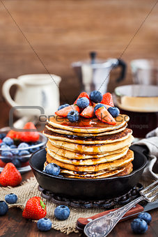 Stack of freshly prepared banana  pancakes with fresh berries