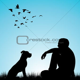 Man and his dog sitting on grass