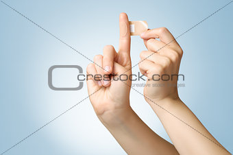 Woman with a plaster on her finger