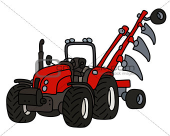 The red tractor with a plow