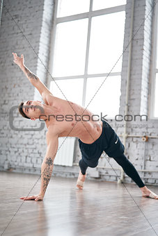 Handsome ballet dancer training in the gym