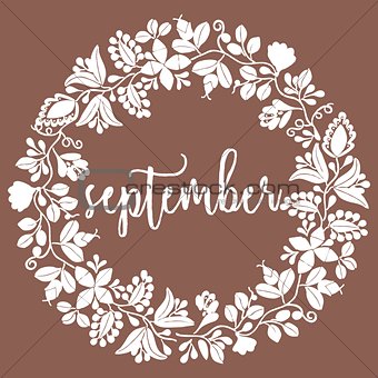 Hand drawn vector september sign with wreath on brown background