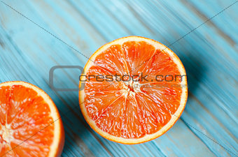 Sliced orange on a blue wooden background 