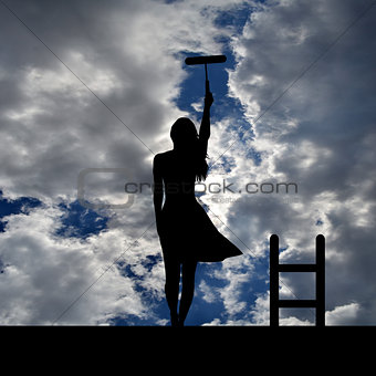 Woman silhouette with ladder on the roof painting the sky