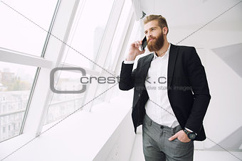 Businessman talking to the phone in office