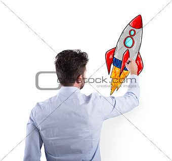 Businessman drawing a rocket. Concept of business improvement and enterprise startup